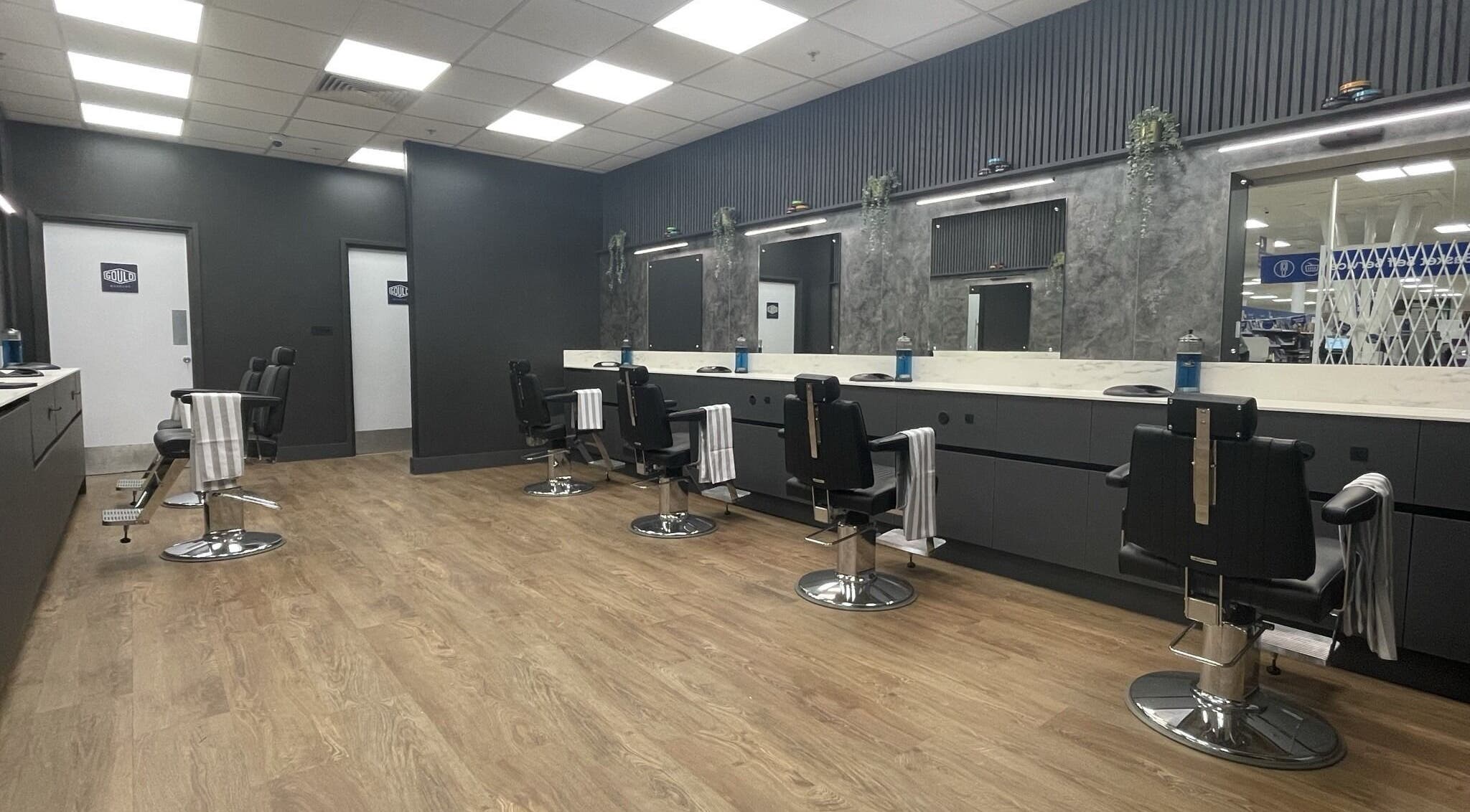 Modern interior of Gould Barbers Portsmouth in Portsmouth, England, GB, showcasing sleek chairs and elegant decor.