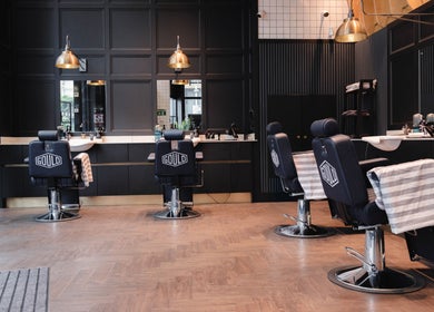 Stylish interior of Gould Barbers London (London Bridge) with sleek barber chairs in London, England, GB.