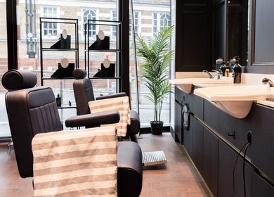 Modern barber chairs at Gould Barbers London (London Bridge), offering a chic grooming experience in London, England, GB.