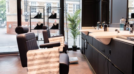 Modern barber chairs at Gould Barbers London (London Bridge), offering a chic grooming experience in London, England, GB.