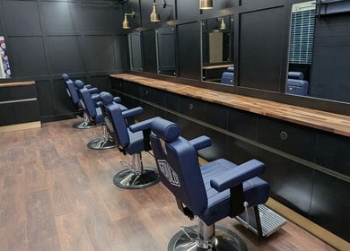 Gould Barbers Lowestoft's modern interior in Lowestoft, England, GB with stylish chairs and mirrors.