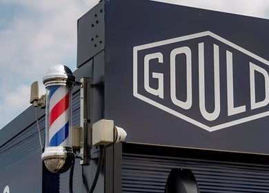 Gould Barbers Lowestoft storefront with barbershop pole in Lowestoft, England, GB.