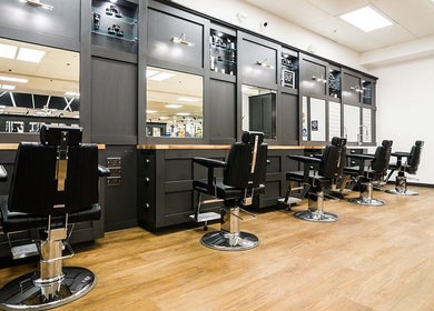 Interior of Gould Barbers Poole featuring sleek barber chairs in Poole, England, GB.