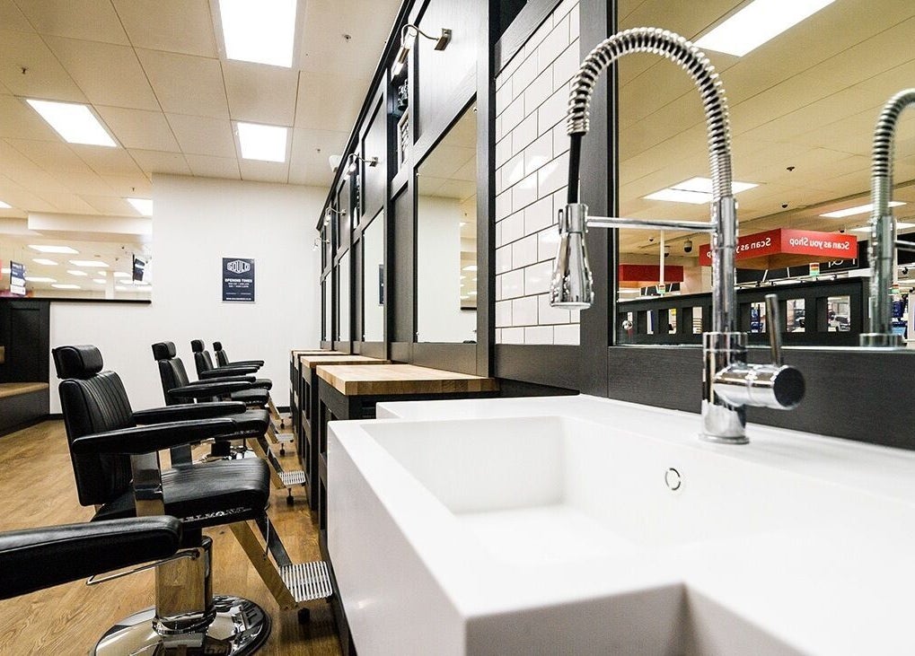 Modern barber chairs and sink at Gould Barbers Poole, Poole, England, GB showcasing sleek salon interior.