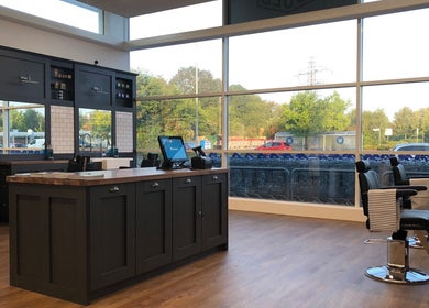 Interior of Gould Barbers Poole, Poole, England, GB with sleek barber chairs and large windows.