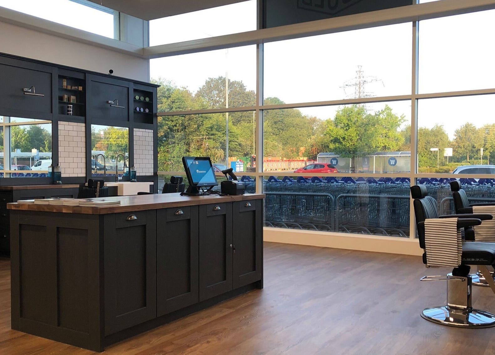 Interior of Gould Barbers Poole, Poole, England, GB with sleek barber chairs and large windows.