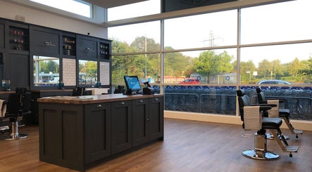 Interior of Gould Barbers Poole, Poole, England, GB with sleek barber chairs and large windows.