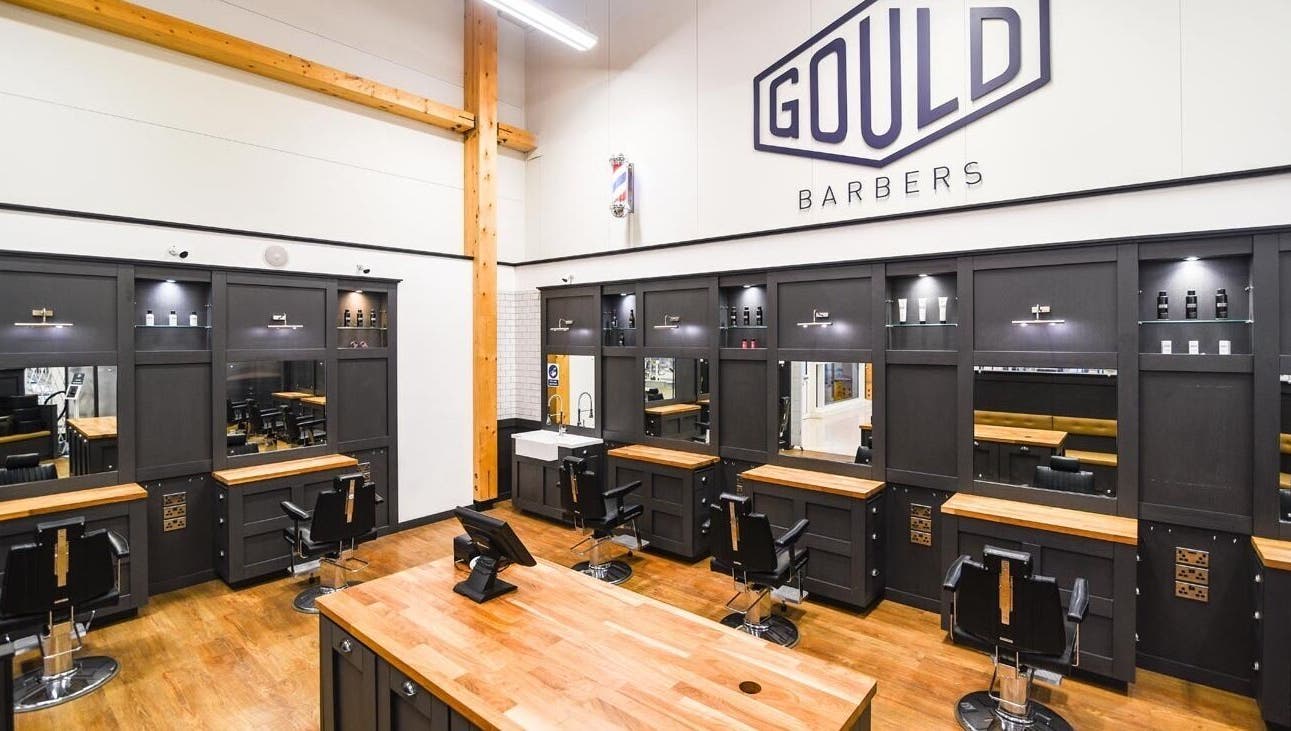 Interior of Gould Barbers Stevenage displaying modern chairs and mirrors in Stevenage, England, GB.