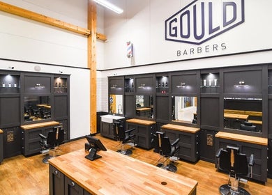 Interior of Gould Barbers Stevenage displaying modern chairs and mirrors in Stevenage, England, GB.