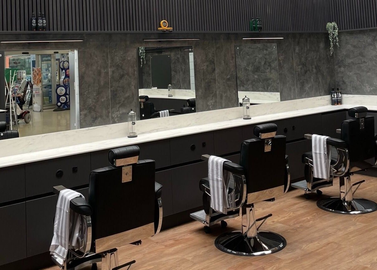 Gould Barbers West Bromwich interior with sleek black barber chairs in West Bromwich, England, GB.