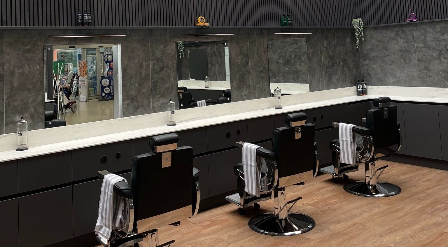Gould Barbers West Bromwich interior with sleek black barber chairs in West Bromwich, England, GB.