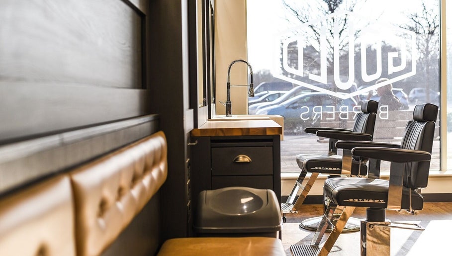 Interior of Gould Barbers Long Eaton, stylish chairs, and window view, Long Eaton, England, GB.
