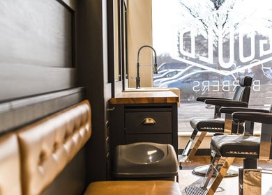 Interior of Gould Barbers Long Eaton, stylish chairs, and window view, Long Eaton, England, GB.