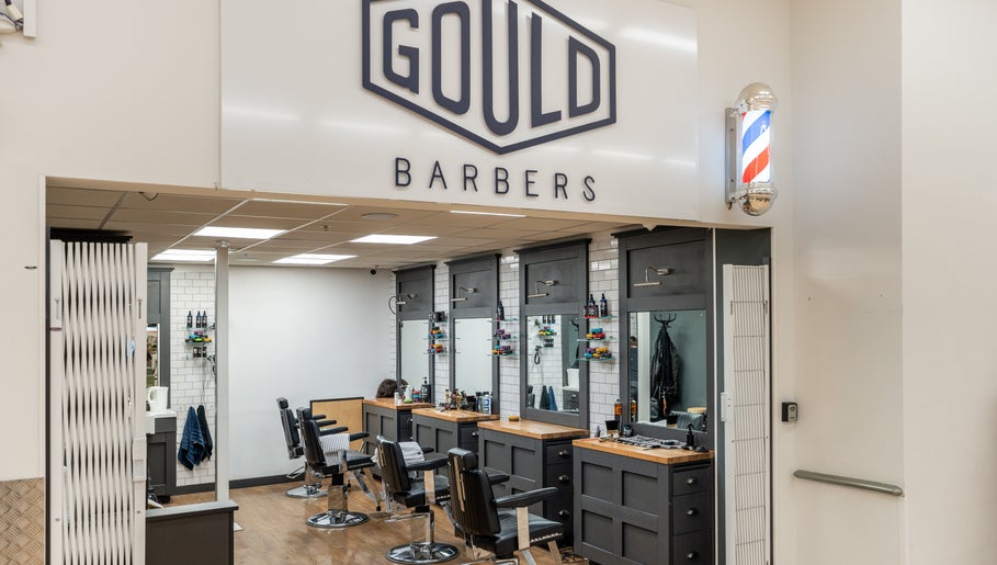 Interior of Gould Barbers Cheshunt, showcasing modern chairs and mirrors in Cheshunt, England, GB.