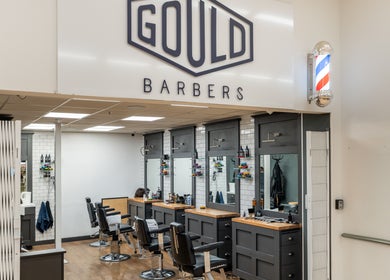 Interior of Gould Barbers Cheshunt, showcasing modern chairs and mirrors in Cheshunt, England, GB.