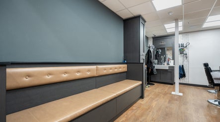 Modern seating and workstation at Gould Barbers Cheshunt, Cheshunt, England, GB, showcasing stylish decor.