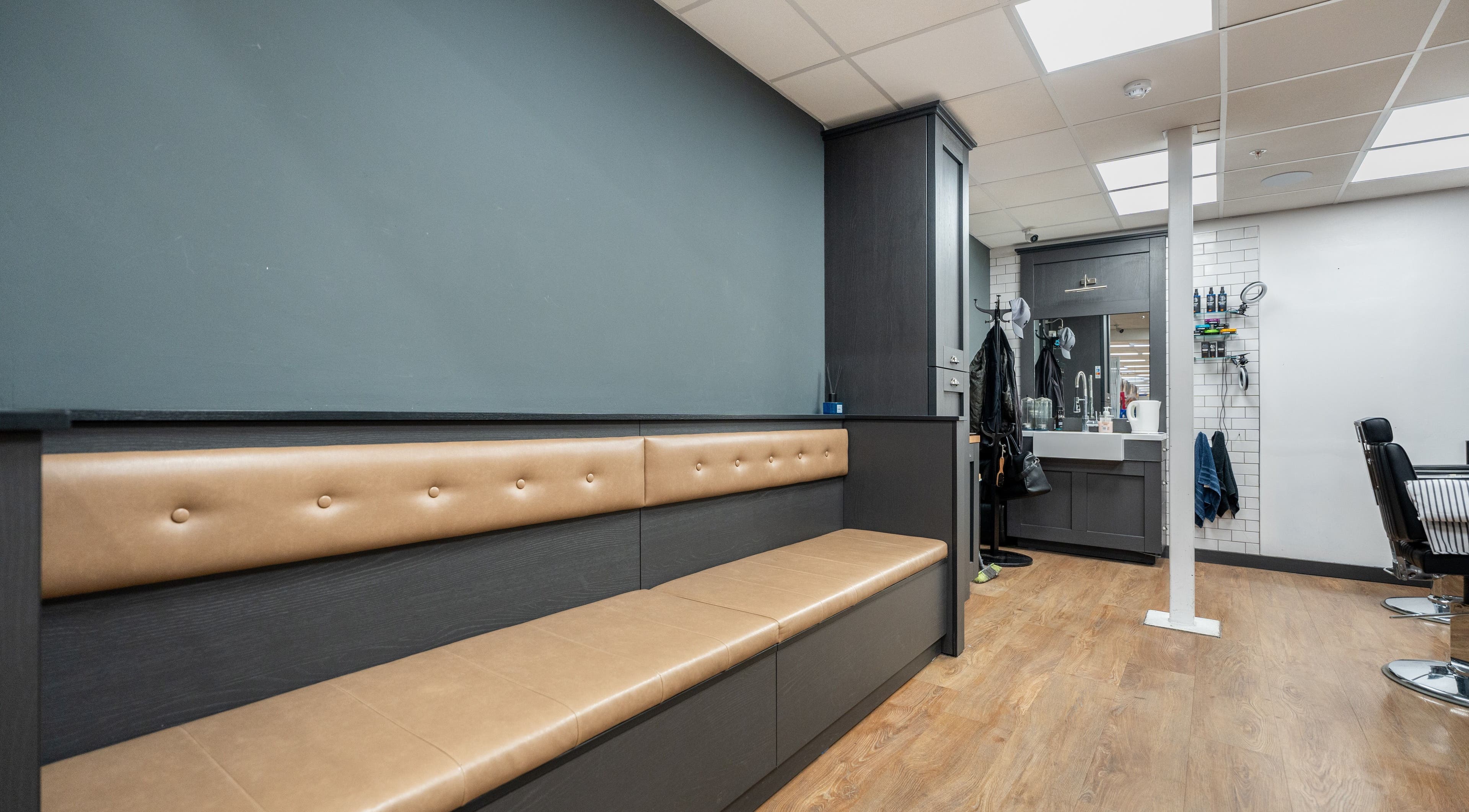 Modern seating and workstation at Gould Barbers Cheshunt, Cheshunt, England, GB, showcasing stylish decor.