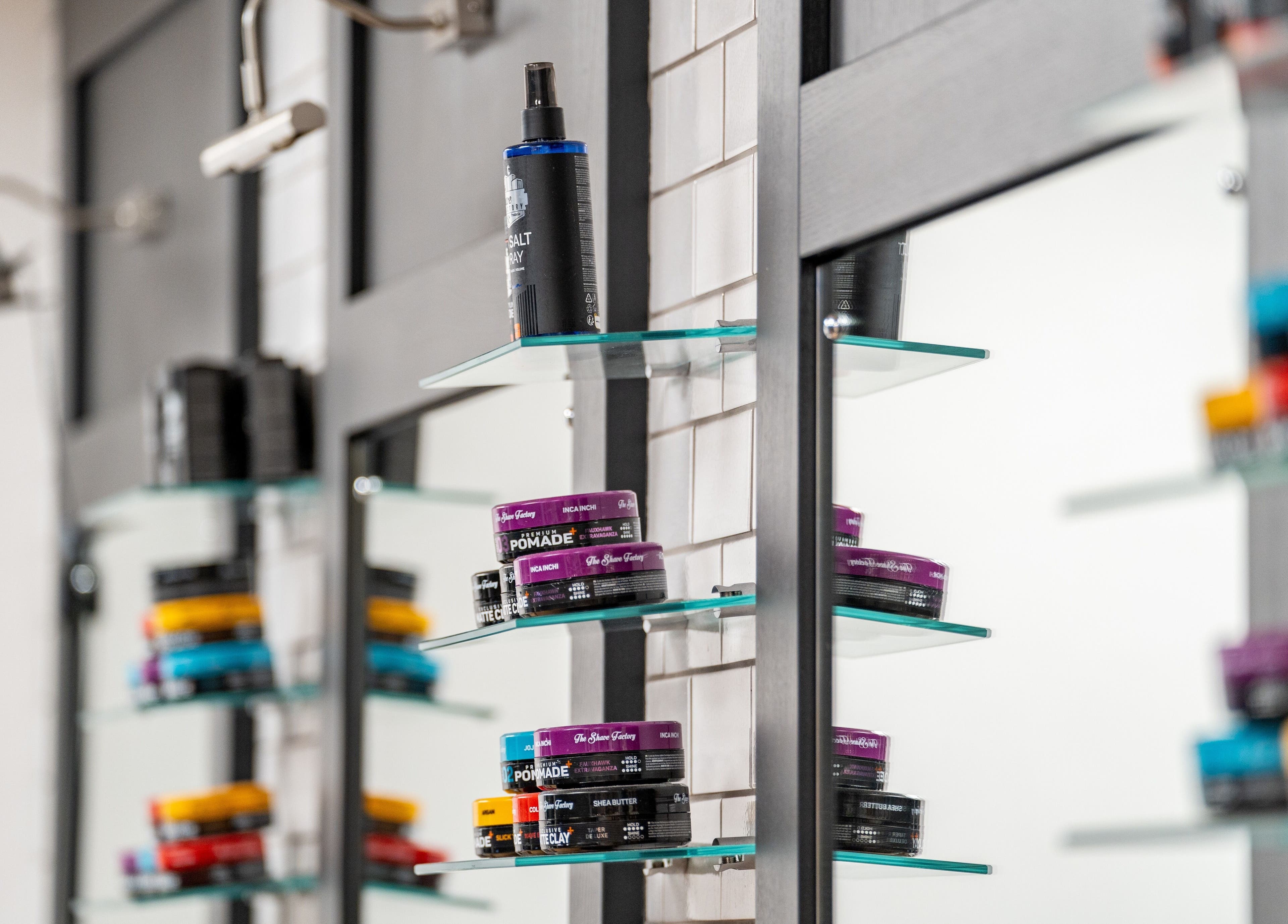 Hair products on glass shelves at Gould Barbers Cheshunt, Cheshunt, England, GB.