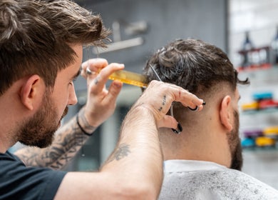 Barber expertly trims hair at Gould Barbers Cheshunt, located in Cheshunt, England, GB.