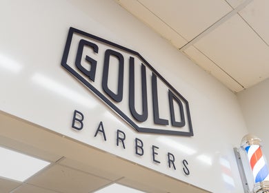 Entrance sign at Gould Barbers Cheshunt, located in Cheshunt, England, GB, featuring classic barber pole.