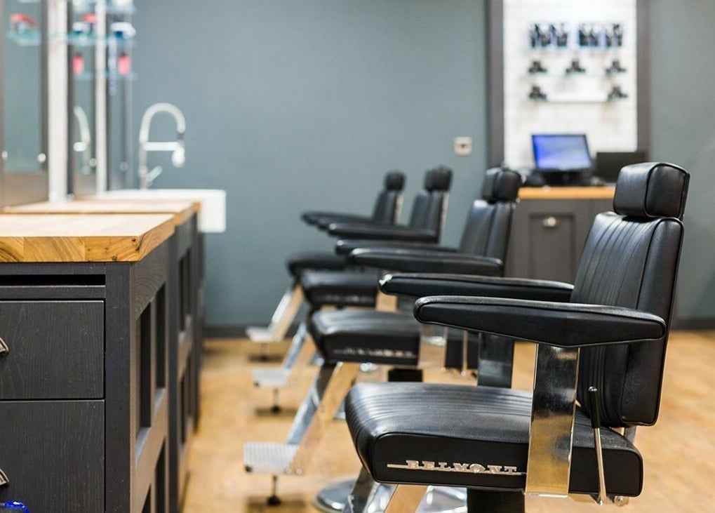 Stylish black barber chairs at Gould Barbers Coventry, Coventry, England, GB, in a modern interior setup.