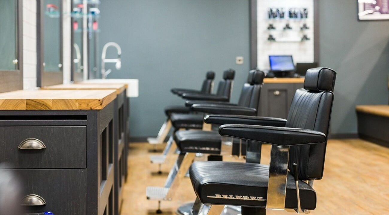 Stylish black barber chairs at Gould Barbers Coventry, Coventry, England, GB, in a modern interior setup.
