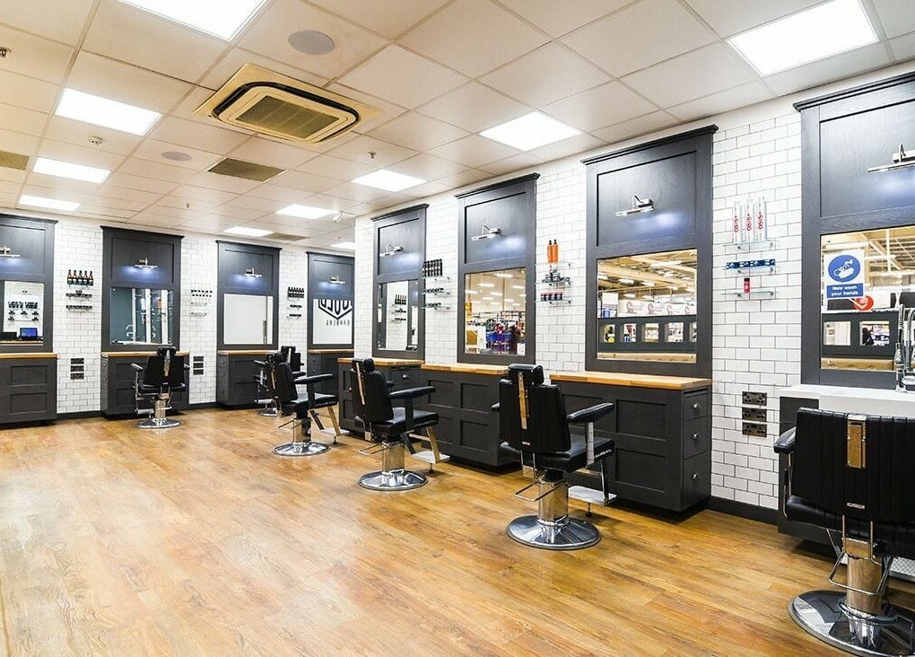 Interior view of stylish Gould Barbers Coventry, featuring sleek black chairs at Coventry, England, GB location.