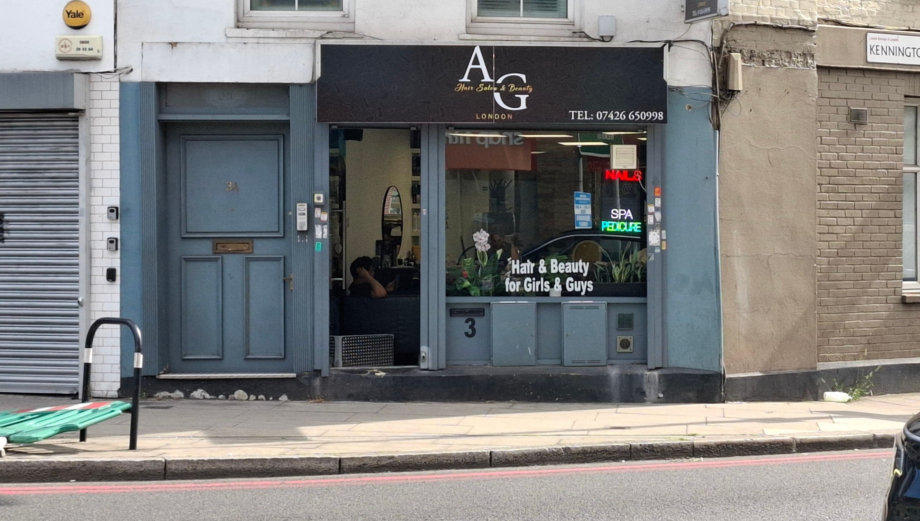 Exterior of AG Hair Salon in London, England, GB, featuring stylish storefront and neon beauty signs.