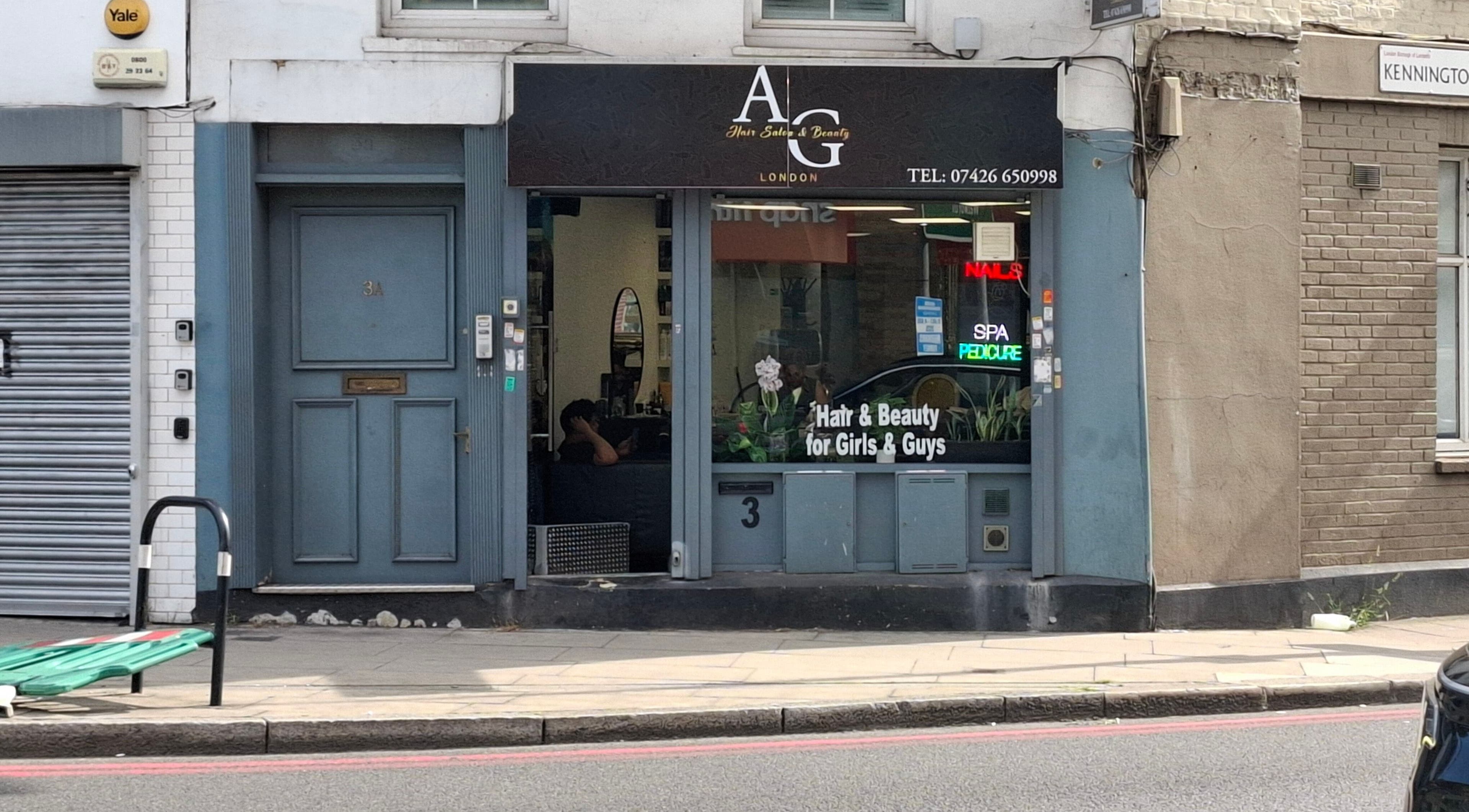 Exterior of AG Hair Salon in London, England, GB, featuring stylish storefront and neon beauty signs.