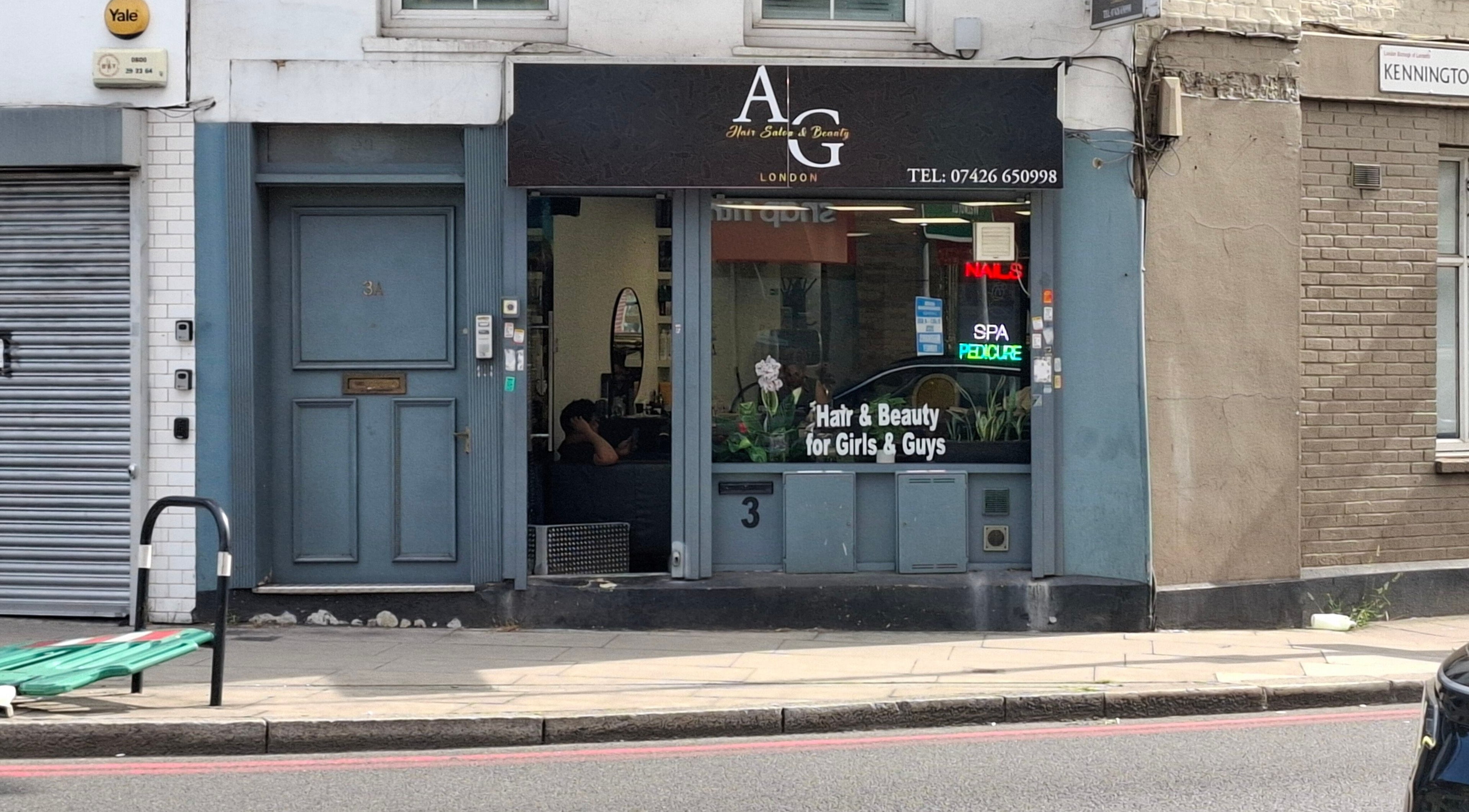 Exterior of AG Hair Salon in London, England, GB, featuring stylish storefront and neon beauty signs.