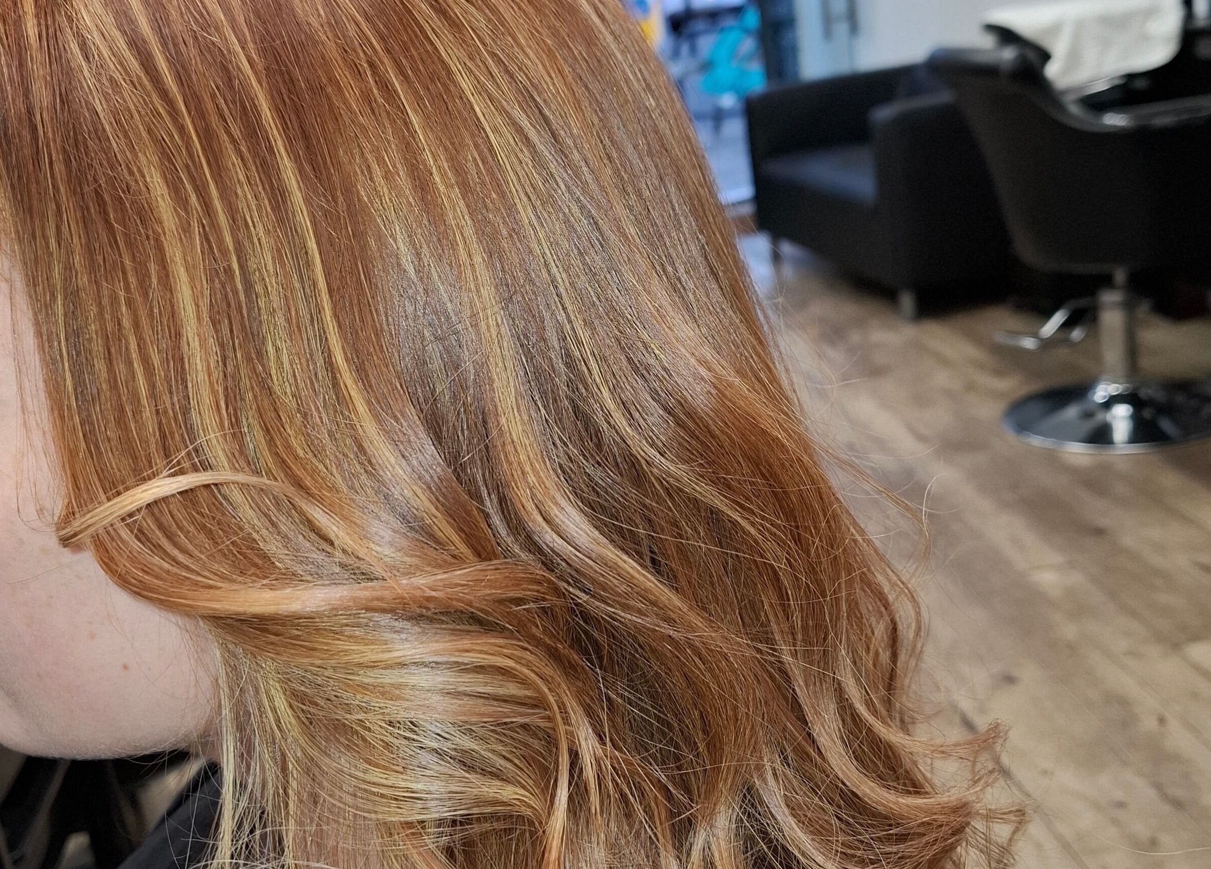 Golden wavy hair styled at AG Hair Salon, London, England, GB. Vibrant look with elegant curls.