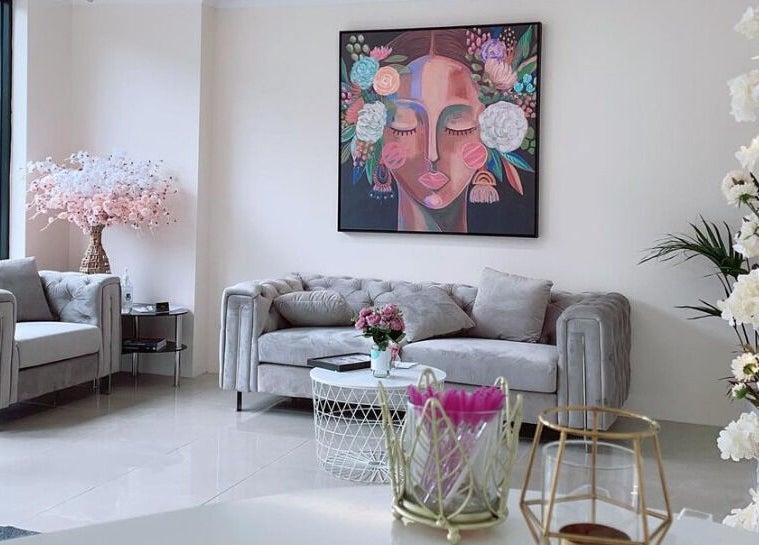 Elegant waiting area at Galaxy Lashes in Melbourne, Victoria, AU featuring chic sofas and vibrant artwork.