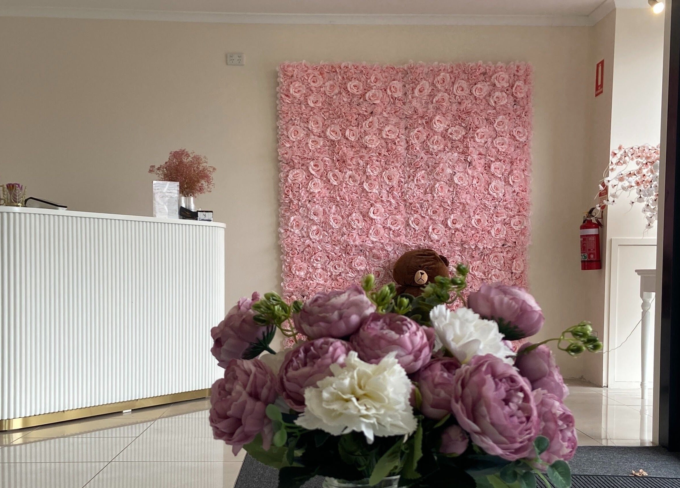 Elegant reception with floral decor at Galaxy Lashes, Melbourne, Victoria, AU showcasing pink rose wall.