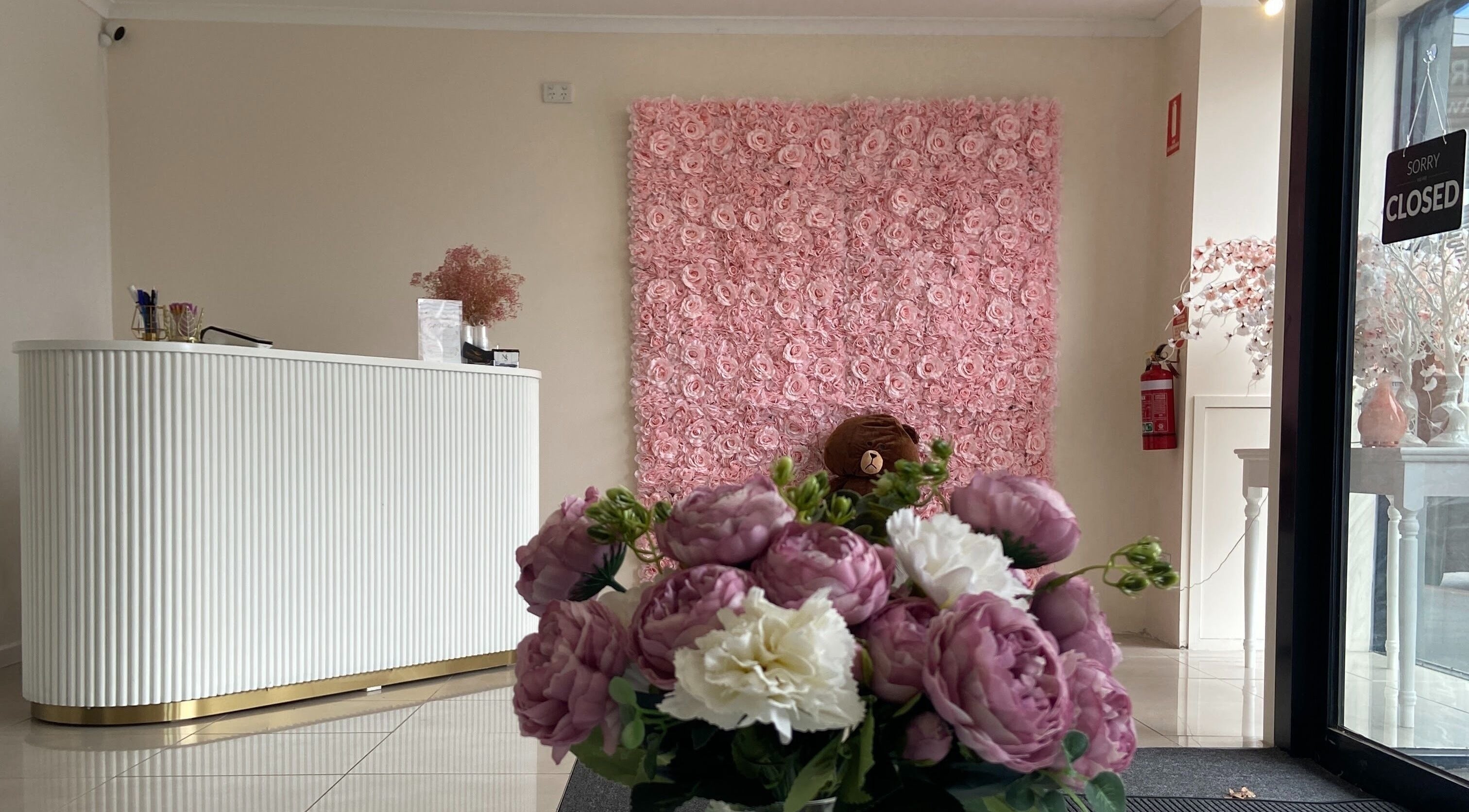 Elegant reception with floral decor at Galaxy Lashes, Melbourne, Victoria, AU showcasing pink rose wall.