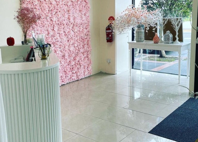 Entrance of Galaxy Lashes with floral decor in Melbourne, Victoria, AU, showcasing elegance and style.