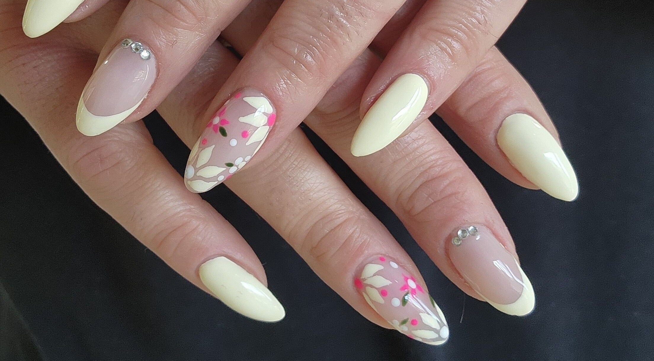 Stylish floral nail art at Esthetics by Mandi, Belle River, Ontario, CA, showcasing exquisite design.