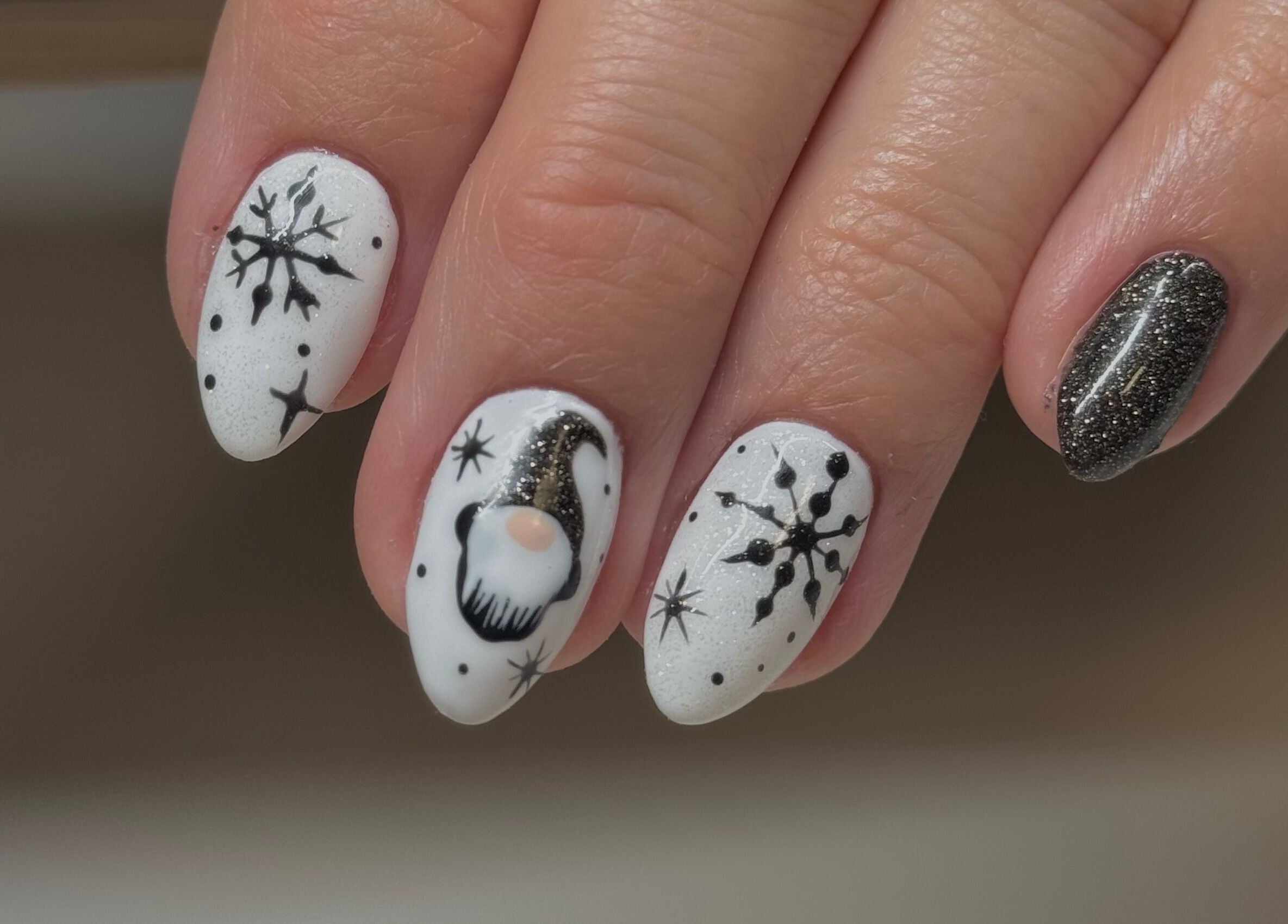 Winter-themed nail art with snowflakes at Esthetics by Mandi, Belle River, Ontario, CA.