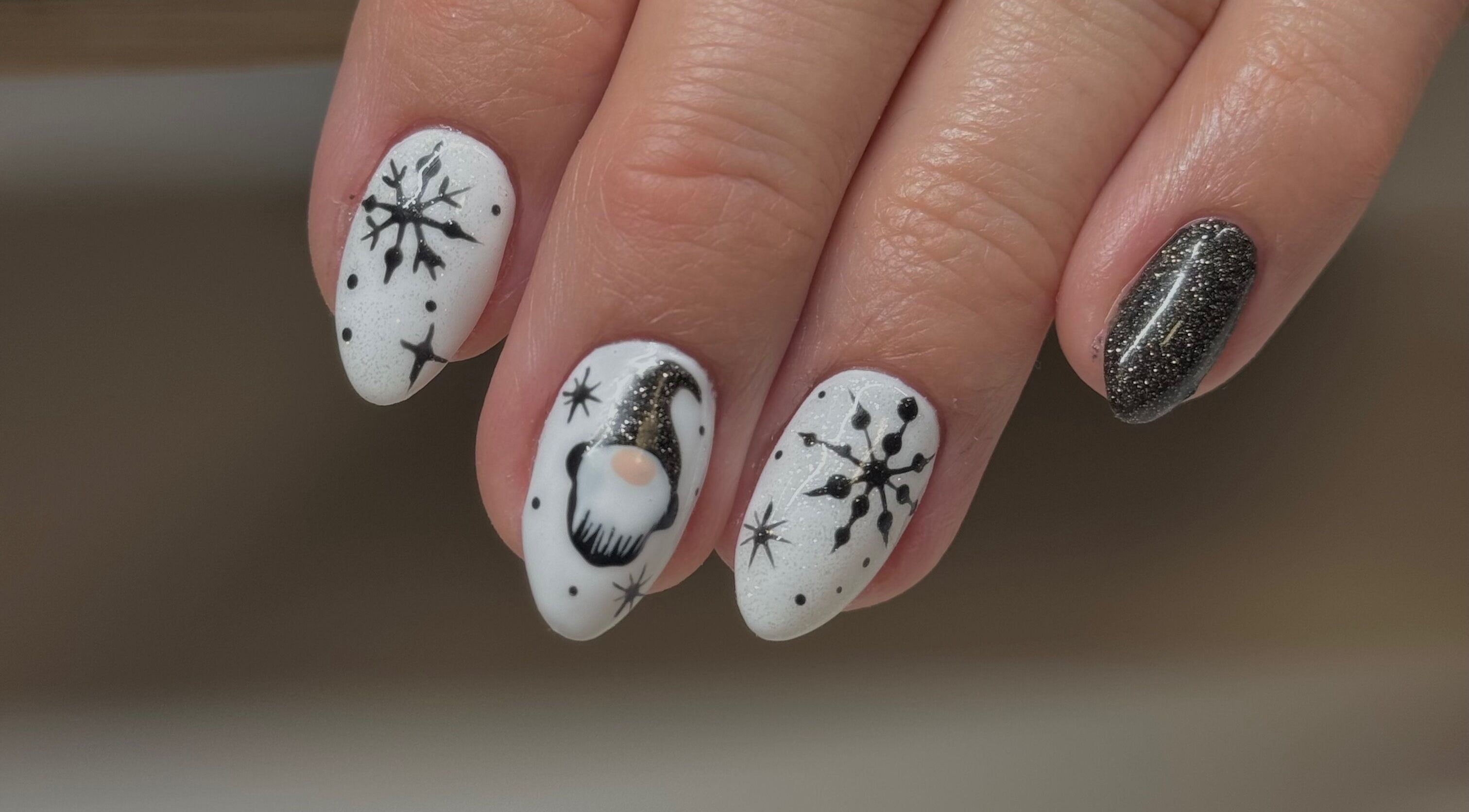 Winter-themed nail art with snowflakes at Esthetics by Mandi, Belle River, Ontario, CA.