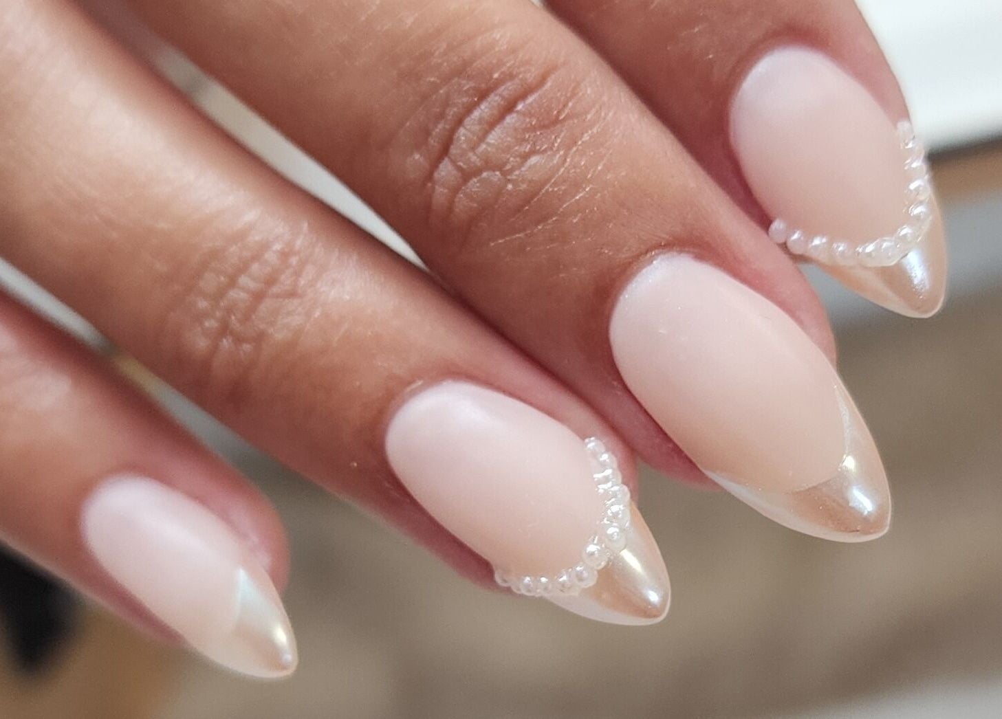 Elegant pearl-accented nails at Esthetics by Mandi in Belle River, Ontario, CA. Modern nail art design.