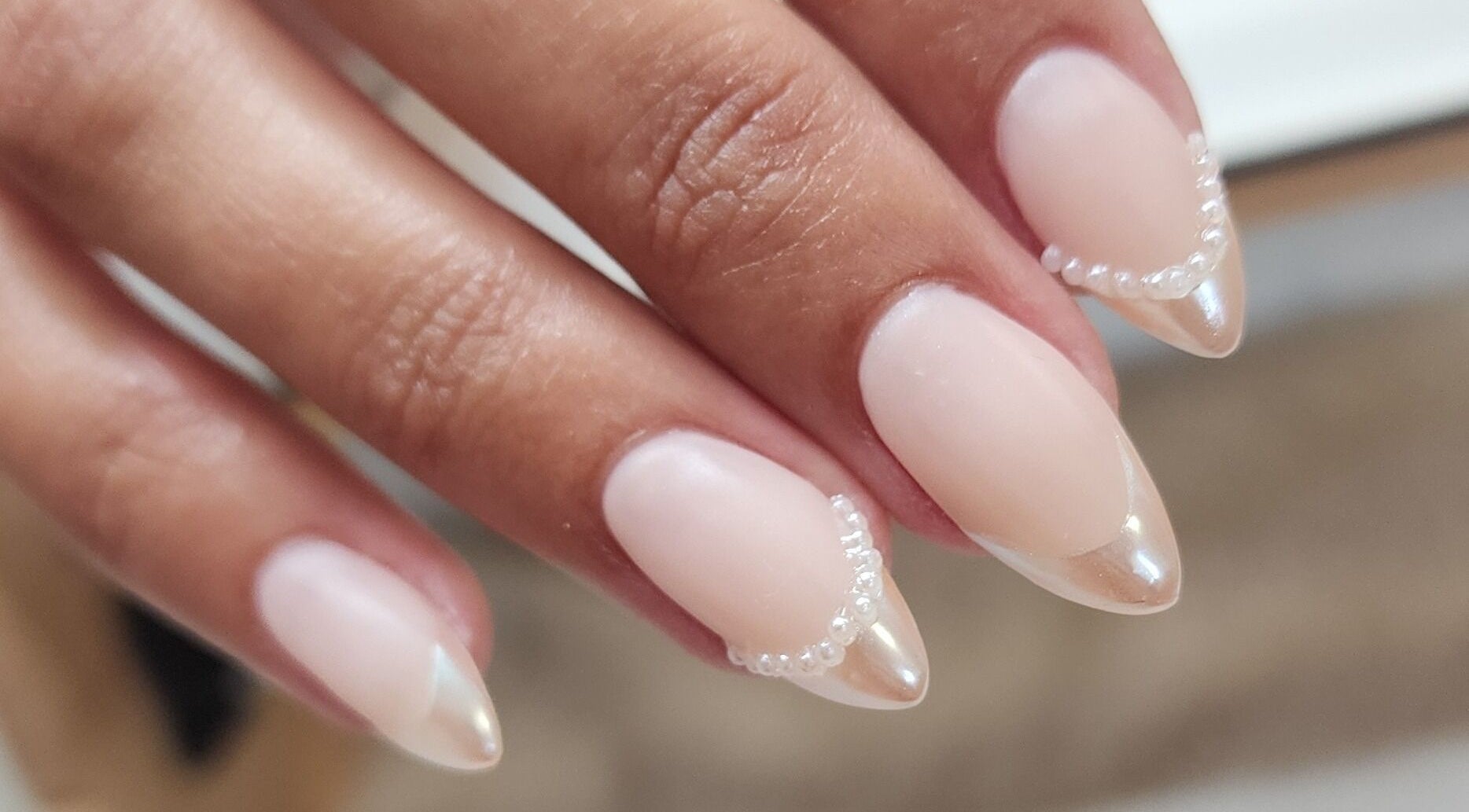 Elegant pearl-accented nails at Esthetics by Mandi in Belle River, Ontario, CA. Modern nail art design.