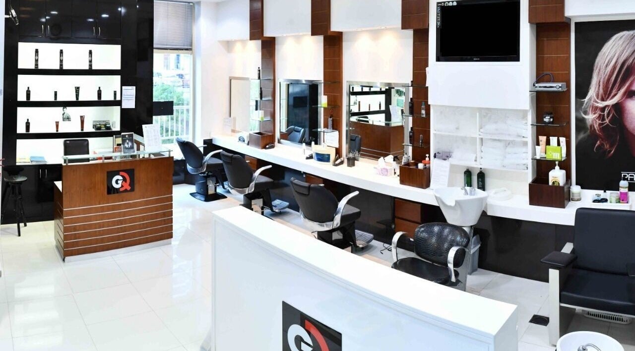 Chic interior of GQ Men's Hair Lounge in Dubai, Dubai, AE, featuring modern salon chairs and sleek decor.