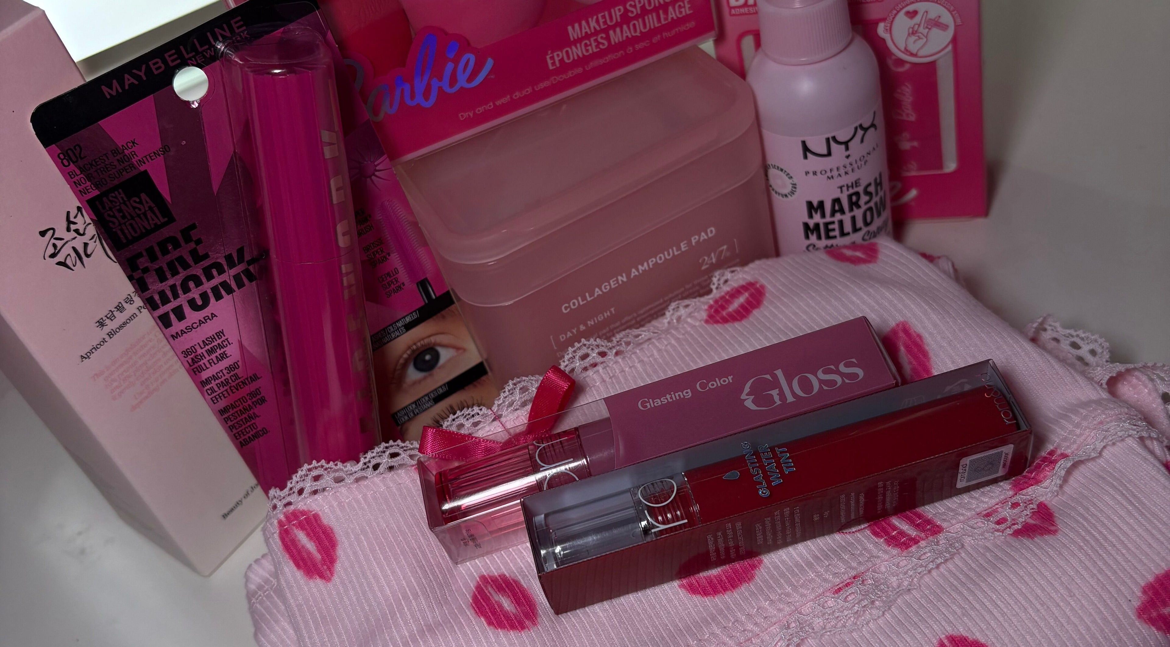 A vibrant beauty product collection at LAU, Toronto, Ontario, CA, featuring makeup essentials in pink packaging.