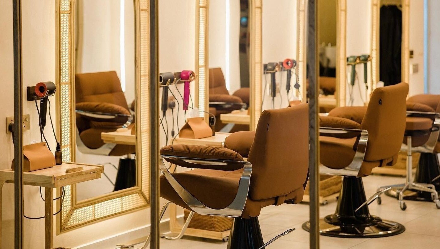 Chic interior of Maldon Salon in Kuala Lumpur, with plush salon chairs and mirrors.