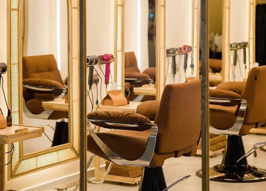 Chic interior of Maldon Salon in Kuala Lumpur, with plush salon chairs and mirrors.