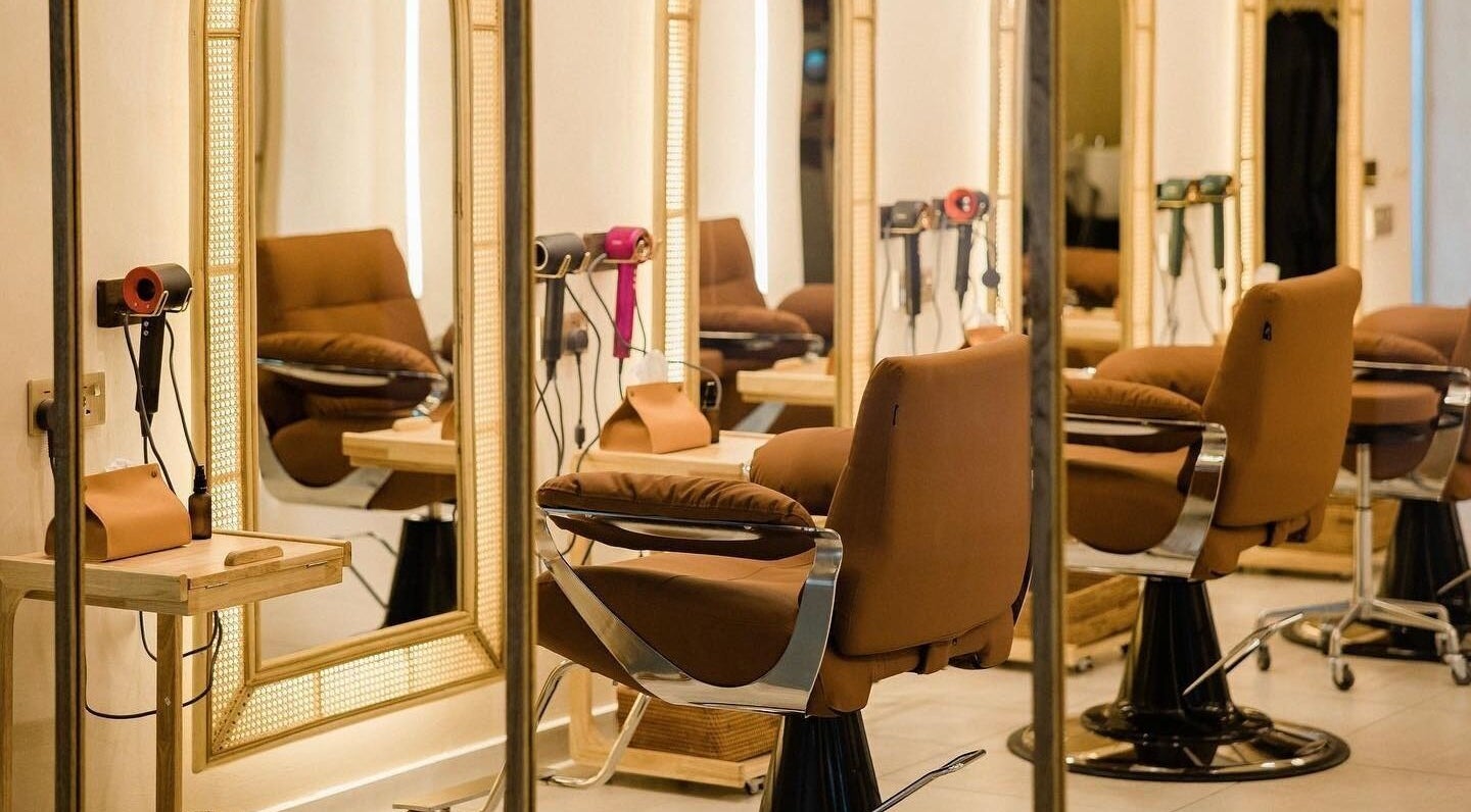 Chic interior of Maldon Salon in Kuala Lumpur, with plush salon chairs and mirrors.
