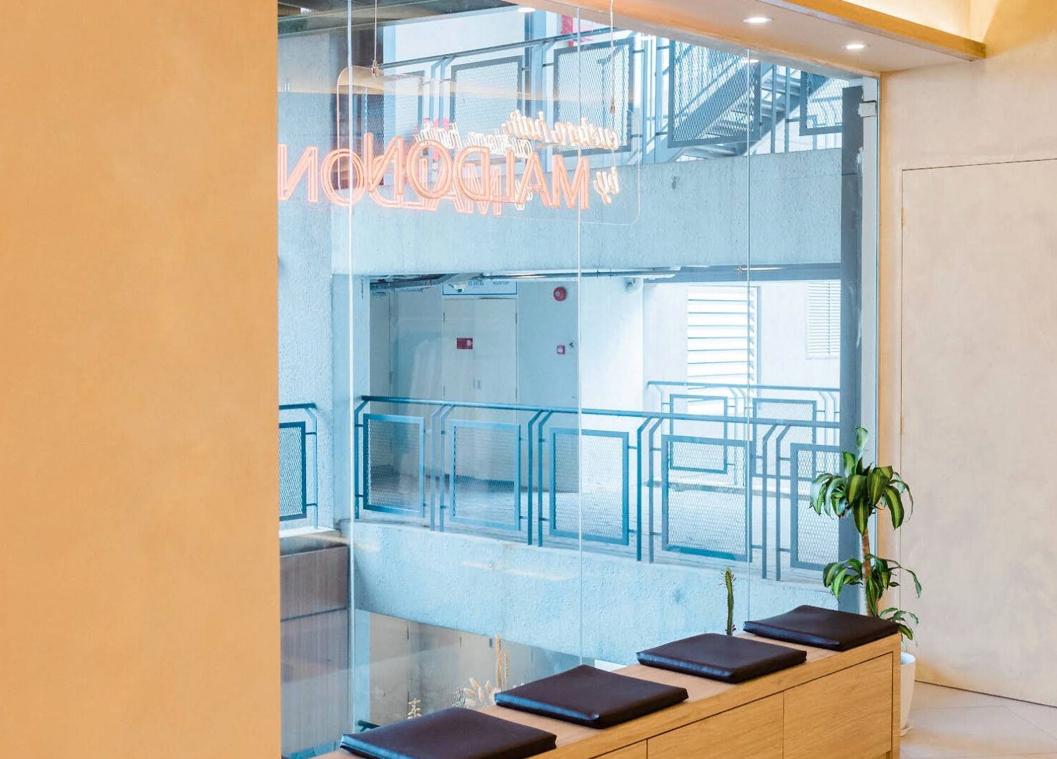 Modern interior view of Maldon Salon in Kuala Lumpur, featuring sleek seating and greenery.