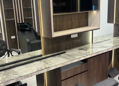Modern salon setup at Gent Station Zayed Town. Features sleek chairs and marble countertops in Zayed Town, BH.