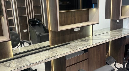 Modern salon setup at Gent Station Zayed Town. Features sleek chairs and marble countertops in Zayed Town, BH.