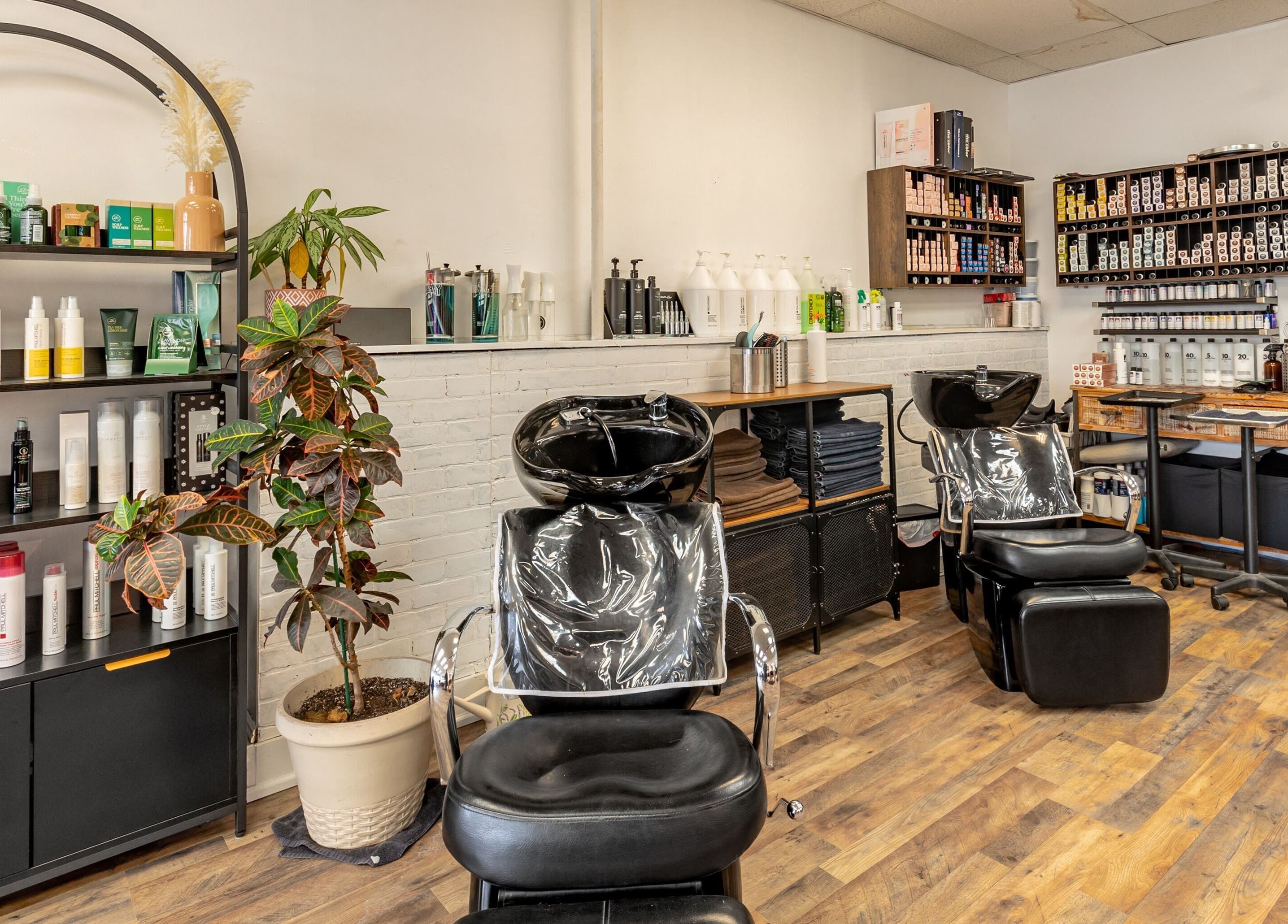 Interior of A&A Hairloft in Mineola, New York, US featuring hair washing stations and product shelves.