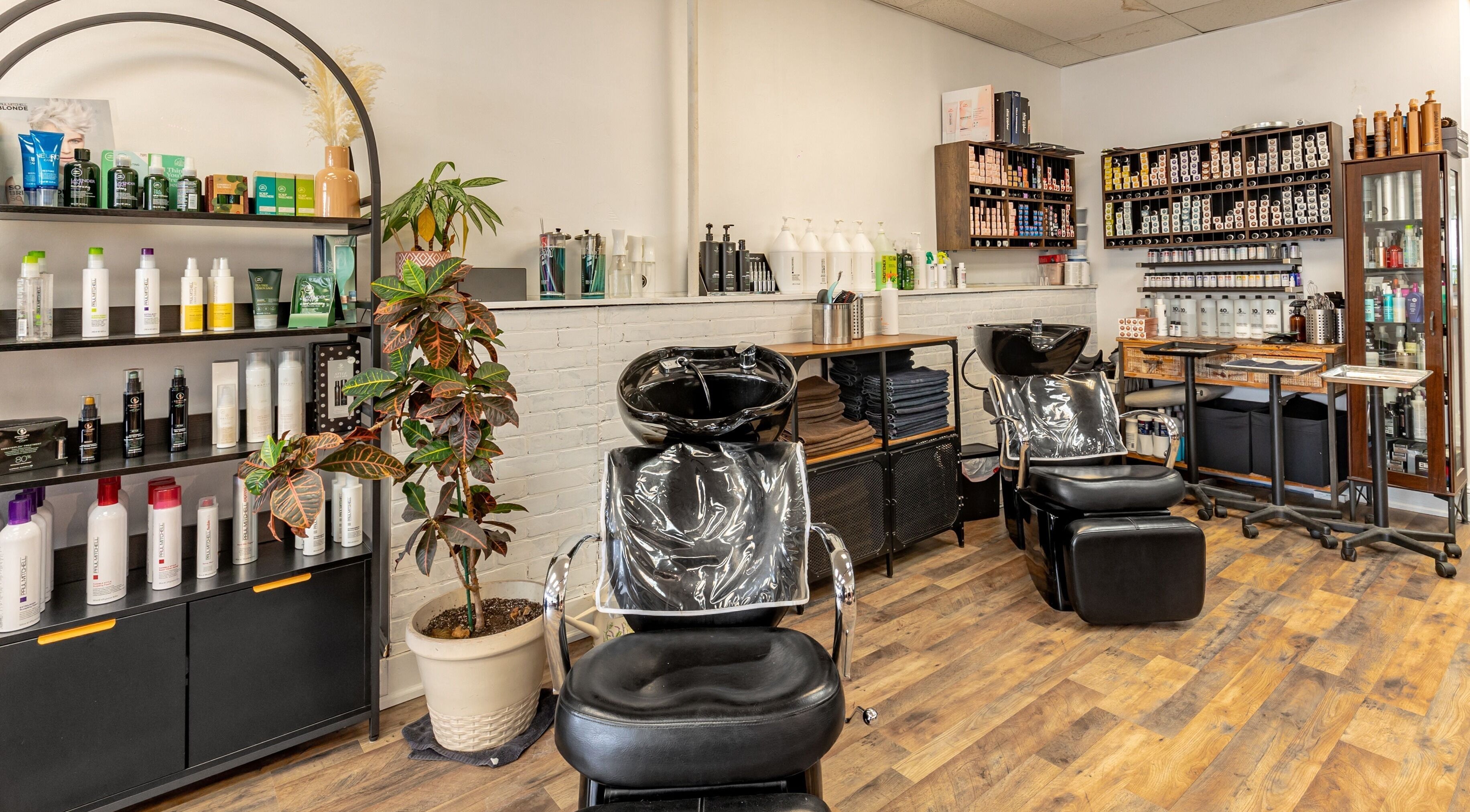 Interior of A&A Hairloft in Mineola, New York, US featuring hair washing stations and product shelves.